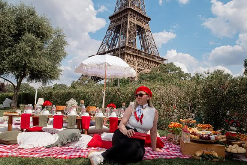 Mesa de piquenique decorada em vermelho e branco diante da Torre Eiffel